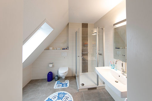 Modernes helles Badezimmer mit ebenerdiger Dusche